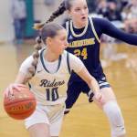 Port Angeles Teanna Clark, front, slips around the defense of Bainbridges Bella Ramirez during Tuesdays game at Port Angeles High School. (Keith Thorpe/Peninsula Daily News)