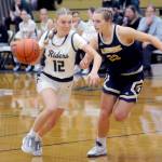 Port Angeles Izzy Felton, left, rolls around Bainbridges Stella Berry on Tuesday night in Port Angeles. (Keith Thorpe/Peninsula Daily News)