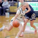 Port Angeles Izzy Felton, front, head for the lane past Bainbridges Elsa Drugge on Tuesday night at Port Angeles High School. (Keith Thorpe/Peninsula Daily News)