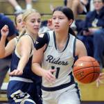 Port Angeles Lindsay Smith, right, edges past Bainbridges Carlyn Moore on Tuesday in Port Angeles. (Keith Thorpe/Peninsula Daily News)