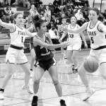partan sisters Bailey Johnson (1) and Keira Johnson (5) get defensive against Chief Leschi in Forks where Forks defeated the Warriors 78 to 26.  Also in the action is Spartan Janessa Ramos (13).  Photo by Lonnie Archibald.