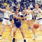 Lonnie Archibald/for Peninsula Daily News
Forks sisters Bailey Johnson, left, and Keira Johnson get defensive against Chief Leschi in Forks, where the Spartans defeated the Warriors 78-26.