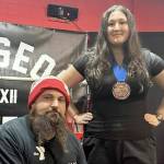 Port Angeles powerlifter Maggie Doyle set four U.S. Powerlifting Association age group records while winning her first powerlifting competition in Bremerton in December. She is shown with her coach, Ryan Fontana of the YMCA of Port Angeles.