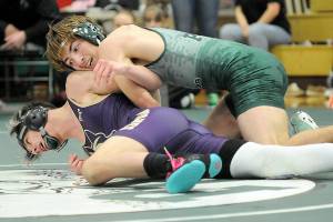 KEITH THORPE/PENINSULA DAILY NEWS
Port Angeles' Anthony McMahan, top, tries to overturn Sequim's Jayms Vilona in the 144-lb. class on Saturday at Port Angeles High School.