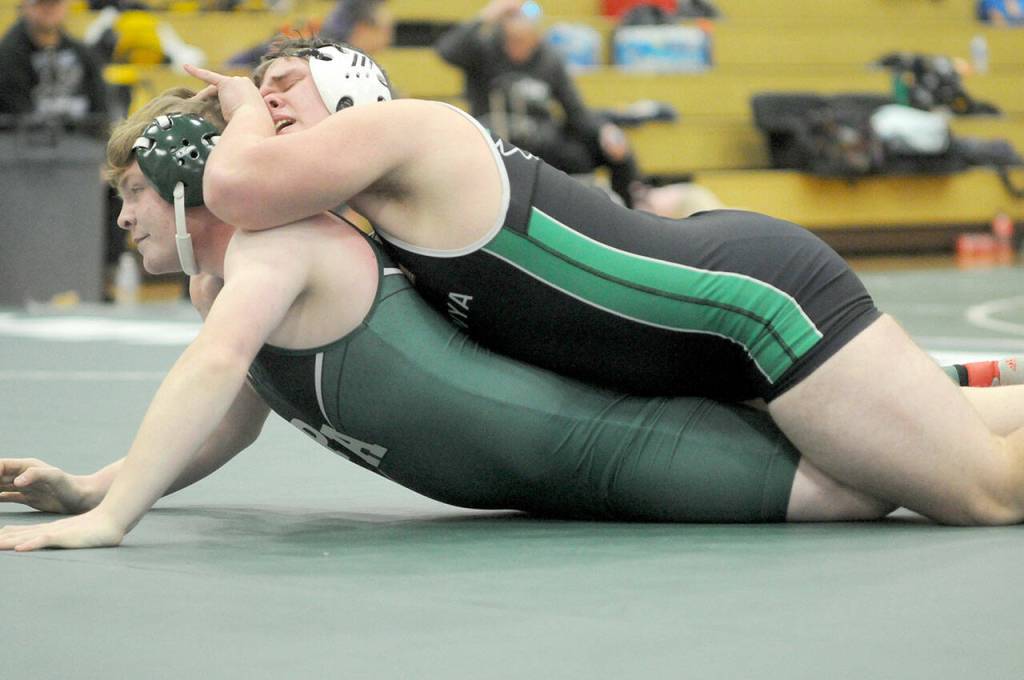 KEITH THORPE/PENINSULA DAILY NEWS Klahowyas Colton Dell, top, struggles to keep above Port Angeles Quinn Messersmith in the 215-lb. division on Saturday at Port Angeles High School.