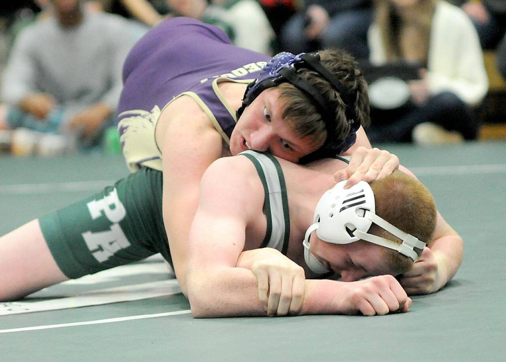 Sequims James Smith, top, takes on Port Angeles Ronan McGuire in the 157-pound weight class at Saturdays Battle of the Axe in Port Angeles. (Keith Thorpe/Peninsula Daily News)