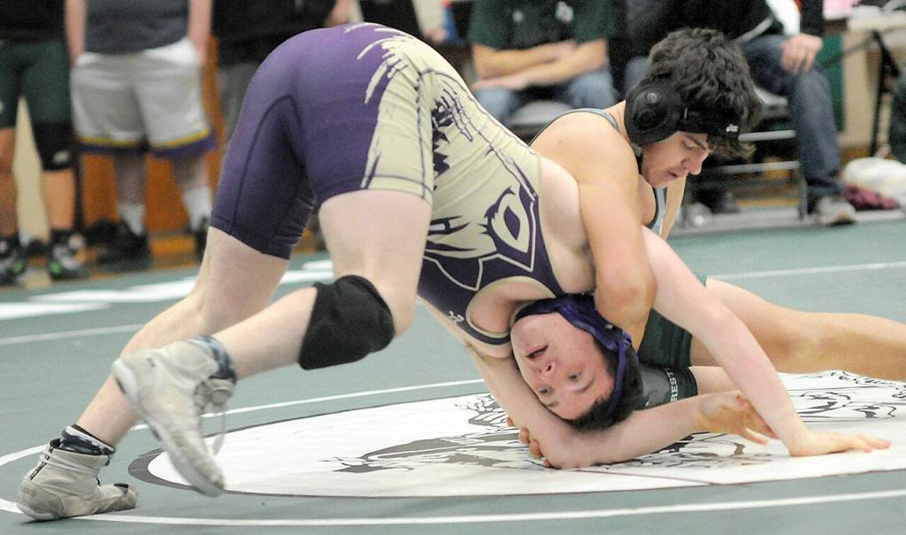 KEITH THORPE/PENINSULA DAILY NEWS 
Sequim's Roger Burwash, front, struggles to keep on his feet against Port Angeles' Oliver Martinez in the 165-lb. division at the Battle for the Axe on Saturday in Port Angeles.