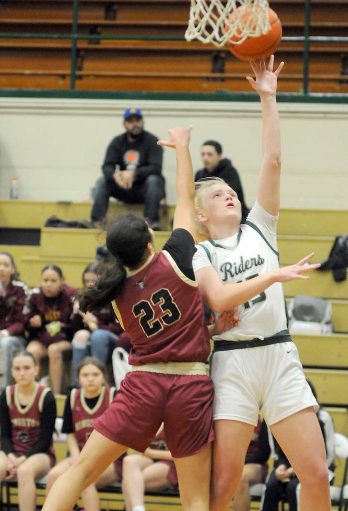 Port Angeles Paige Mason, right, goes for the quick layup as Kingstons Taizah Franklin defends the lane on Tuesday night in Port Angeles. (Keith Thorpe/Peninsula Daily News)