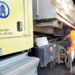 Clallam County Road Department maintenance worker Jeremy Reeves loads a set of tire chains onto a county sand truck on Wednesday at the county shop in Port Angeles in preparation for potential snow on the North Olympic Peninsula. (Keith Thorpe/Peninsula Daily News)