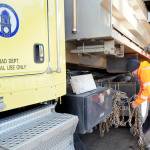 Clallam County Road Department maintenance worker Jeremy Reeves loads a set of tire chains onto a county sand truck on Wednesday at the county shop in Port Angeles in preparation for potential snow on the North Olympic Peninsula. (Keith Thorpe/Peninsula Daily News)
