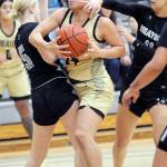 KEITH THORPE/PENINSULA DAILY NEWS Peninsulas Shania Moananu, center, squeezes between Whatcoms Ella Huyntington, left, and Alexa Rodriguez on Wednesday night at Peninsula College.