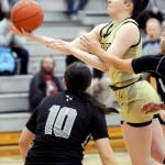 KEITH THORPE/PENINSULA DAILY NEWS Peninsulas Alexa Mackey looks for the layin over the head of Whatcoms Benemi Sanchez on Wednesday in Port Angeles.