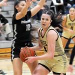 KEITH THORPE/PENINSULA DAILY NEWS Peninsulas Alexa Mackey drives to the lane as Whatcoms Haley Ostrander tries to defend on Wednesday night at Peninsula College.
