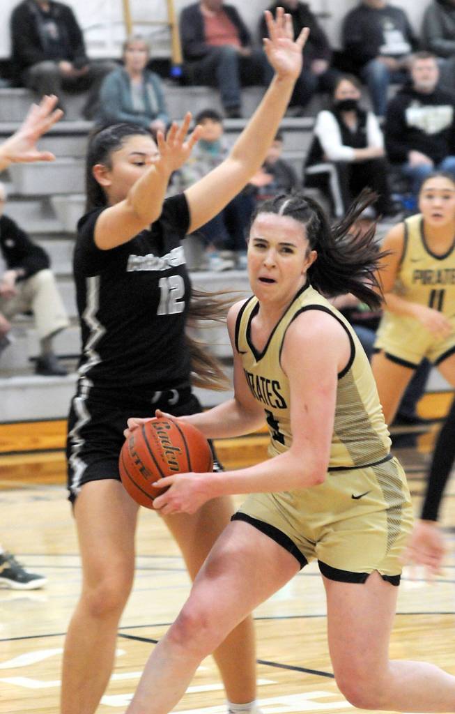 KEITH THORPE/PENINSULA DAILY NEWS Peninsulas Alexa Mackey drives to the lane as Whatcoms Haley Ostrander tries to defend on Wednesday night at Peninsula College.