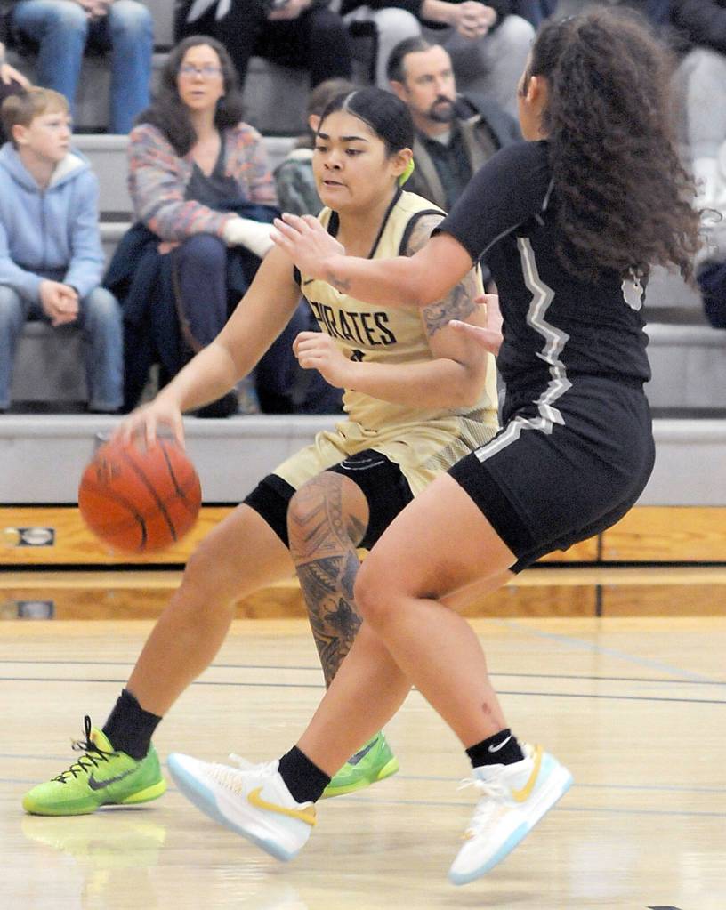 KEITH THORPE/PENINSULA DAILY NEWS Peninsulas Ciera Agasiva, left, slips into the corner as Whatcoms Kyla Miller ties to hold her off on Wednesday night in Port Angeles.