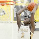 KEITH THORPE/PENINSULA DAILY NEWS 
Peninsula's Ese Onakpoma makes a slam dunk after a quick steal against Whatcom on Wednesday evening in Port Angeles. Looking on is Whatcom's Glenn Wabaluku.