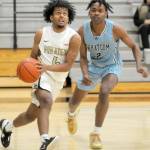 KEITH THORPE/PENINSULA DAILY NEWS Peninsulas Patrick Odingo, left, sets up his layup pursued by Whatcoms Josh Russ on Wednesday in Port Angeles.