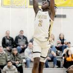 KEITH THORPE/PENINSULA DAILY NEWS Peninsulas Ese Onakpoma makes a slam dunk after a quick steal against Whatcom on Wednesday evening in Port Angeles. Looking on is Whatcoms Glenn Wabaluku.