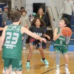 Eighty teams, some from as far away as Anacortes, Stanwood and Enunclaw, braved the road conditions to play in the annual Port Angeles Martin Luther King Jr. youth basketball tournament Saturday and Sunday. Games were played at Stevens Middle School, Roosevelt Elementary, Dry Creek, Lower Elwha and Queen of Angels. Here, Port Angeles sixth-grader Justin Johnson (3) looks to the basket against a team from Neah Bay as Port Angeles Logan Garling (23) is in on the play. Neah Bay won 57-42 in the game played at Stevens Middle School. (Dave Logan/for Peninsula Daily News)