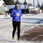 Katherine Hennessy of Port Angeles goes out for a morning jog on Cedar Street on upper Pine hill in Port Angeles on Tuesday. She said the cold and snowy weather doesnt deter her from training for future distance runs. (Dave Logan/for Peninsula Daily News)