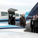 Clint Ostler, president of Dash Air Shuttle, right, points out features of the Cessna 402C aircraft to Peter Metz, left, and Kim Reynolds, both of Port Angeles, during an open house for the air service on Tuesday at William R. Fairchild International Airport in Port Angeles. (KEITH THORPE/PENINSULA DAILY NEWS)