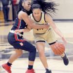 Peninsulas Shania Moananu, right, is held by Bellevues Alicia Morrison on Wednesday night at Peninsula College. (Keith Thorpe/Peninsula Daily News)