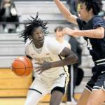 Peninsulas Ese Onakpoma, left, eyes his opponent, Bellevues Mehki Alexander, during Wednesdays game at Peninsula College. (Keith Thorpe/Peninsula Daily News)