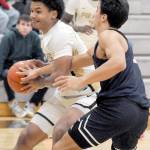 Peninsulas Javon Ervin, left, repels the defense of Bellevues Jamison Carlisle on Wednesday in Port Angeles. (Keith Thorpe/Peninsula Daily News)