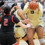 Peninsulas Jelissa Julmist, right, looks for her chance at the goal as teammate Jenilee Donovan, center, fends off the Olympic defense, including Nohea Morrison, left, on Saturday at Peninsula College. (Keith Thorpe/Peninsula Daily News)