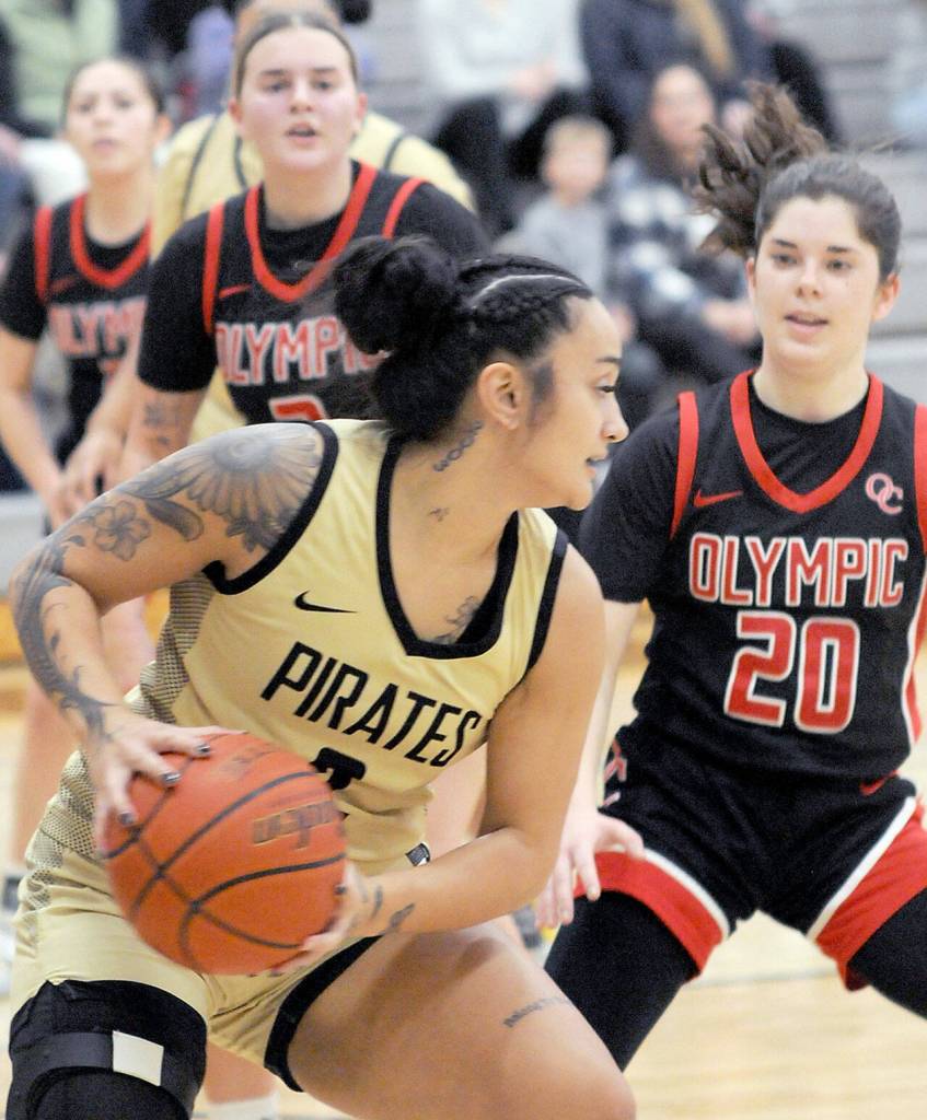 Peninsulas Sunny Pedebone, front, looks to pass defended by Olympics Marina Spitzer, right, and Suzanne Skinner, left, on Saturday in Port Angeles. (Keith Thorpe/Peninsula Daily News)