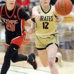 Peninsulas Hannah Bates, right, makes a running pass pursued by Olympics Marina Spitzer on Saturday at Peninsula College. (Keith Thorpe/Peninsula Daily News)