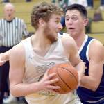 KEITH THORPE/PENINSULA DAILY NEWS 
Port Angeles' Isaiah Shamp, front, picks his path to the lane as Bainbridge's Will Rohrbacher tries to hold him off on Thursday in Port Angeles.