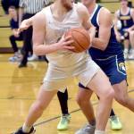 KEITH THORPE/PENINSULA DAILY NEWS Port Angeles Isaiah Shamp, front, picks his path to the lane as Bainbridges Will Rohrbacher tries to hold him off on Thursday in Port Angeles.