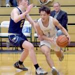 KEITH THORPE/PENINSULA DAILY NEWS Port Angeles Kason Albaugh, right, slips around Bainbridges Calum McCarter during Thursdays game on the Roughrider home court.