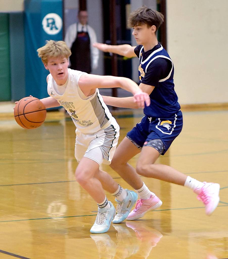 KEITH THORPE/PENINSULA DAILY NEWS Port Angeles Gus Halberg, left, avoids being tripped up by Bainbridges Kaden Thielman on Thursday in Port Angeles.