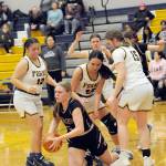 Forks players, from left, Janessa Ramos, Brynn Daniels and Fynlie Peters trap Ocostas Anna Davis Friday night in Forks during senior night for the Spartans. Looking on is Forks Bailey Johnson. Forks defeated Ocosta 59-31. (Lonnie Archibald/for Peninsula Daily News)