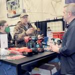 Jack and Marcella Ridge of Sequim talk about power tools with Tony Contestable, tool specialist with Hartnagel Building Supply of Port Angeles, right, during last years Building, Remodeling & Energy Expo in the Sequim High School gym. This years two-day event is scheduled for Saturday and Sunday. (Keith Thorpe/Peninsula Daily News)