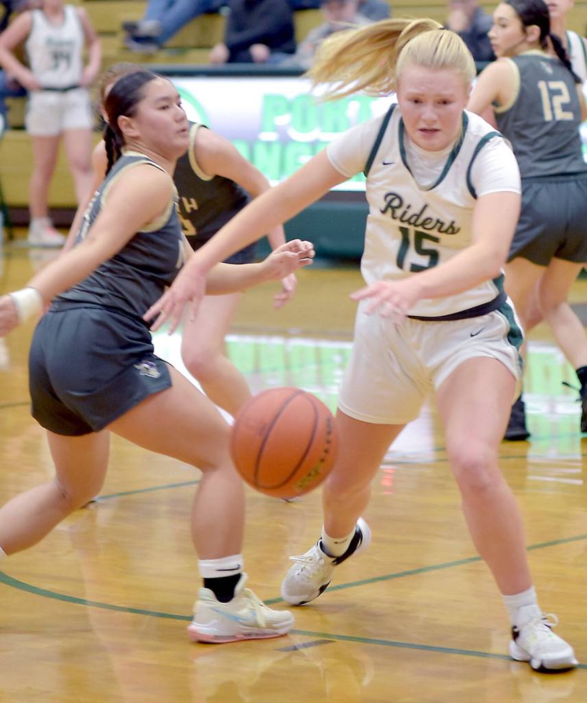 Port Angeles Paige Mason, right, reaches for a loose rebound ahead of North Kitsaps Tiffany Le on Tuesday night in Port Angeles. (Keith Thorpe/Peninsula Daily News)