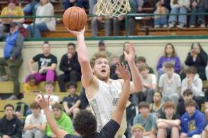 Port Angeles Isaiah Shamp aims for the basket as North Kitsaps Jordan Williams defends the lane on Tuesday night at Port Angeles High School. (Keith Thorpe/Peninsula Daily News)