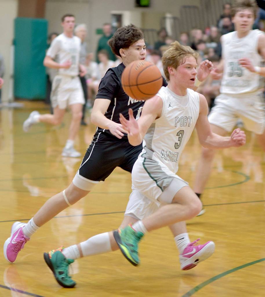 Port Angeles Gus Halberg, right, lets the ball get away from him as he sweeps past North Kitsaps Preston Keehn on Tuesday night in Port Angeles. (Keith Thorpe/Peninsula Daily News)
