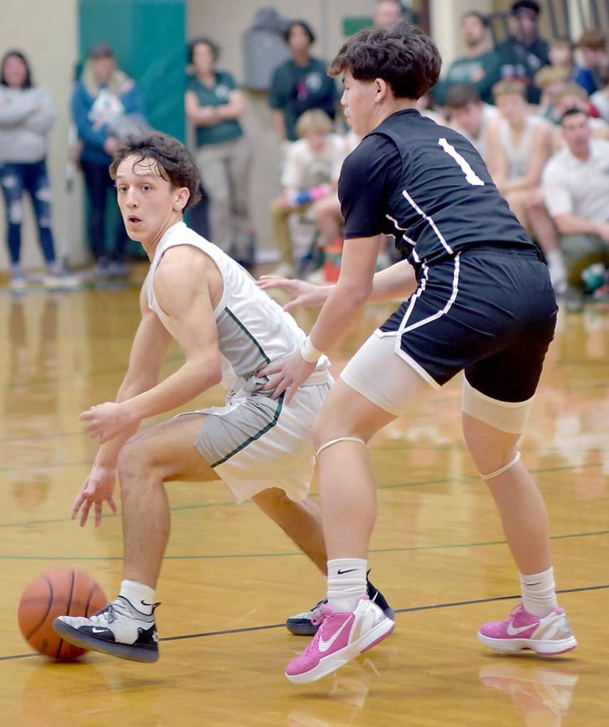 Port Angeles Kason Albaugh, left, searches for a way around the defense of North Kitsaps Preston Keehn on Tuesday in Port Angeles. (Keith Thorpe/Peninsula Daily News)