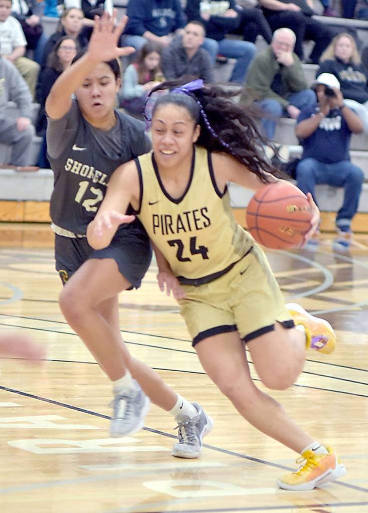 Peninsulas Shania Moananu, right, drives past Shorelines Mailana Mattos on Wednesday night in Port Angeles. (Keith Thorpe/Peninsula Daily News)