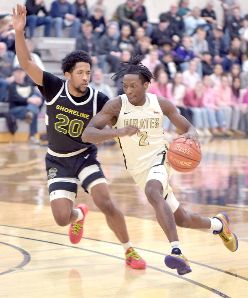 Peninsulas Ese Onakpoma, right, races with Shorelines Jamikal Davis on Wednesday in Port Angeles. (Keith Thorpe/Peninsula Daily News)