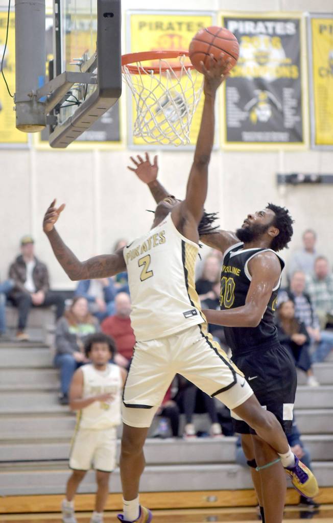 Peninsulas Ese Onakpoma, left, goes up for the drop in as Shorelines Coz Collins tries to hold him off during Wednesdays game in Port Angeles. (Keith Thorpe/Peninsula Daily News)