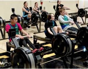From left, Olympic Peninsula Rowing Associations Mason Mai, 13, Quince Chanway, 12, and Teig Carlson, 14, warm up for the mens under 15 2,000 meter indoor rowing event. (Olympic Peninsula Rowing Association)