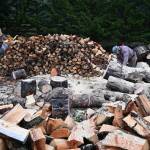 From left, Jack Tatom, Wally Jenkins and Dan Kalinski cut, chop and split wood for cords, whose sales go directly to help the Path From Poverty nonprofit. (Michael Dashiell/Olympic Peninsula News Group)