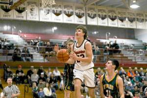 Napavines Cal Bullock, center, splits the defense of Forks Kyle Lohrengel and Dylan Micheau during a Class 2B Southwest District Tournament game at W.F. West High School in Chehalis. (Dylan Wilhelm/The Chronicle)