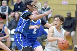 KEITH THORPE/PENINSULA DAILY NEWS 
Port Angeles' Kason Albaugh, right, tries to avoid being boxed in by Bremerton's Frank Allen, left, and Trenton Bulmer on Thursday in Port Angeles.