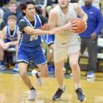 KEITH THORPE/PENINSULA DAILY NEWS Port Angeles Isaiah Shamp, right, heads for the lane as Bremertons Isaiah Cadengo closes in on Thursday night in Port Angeles.