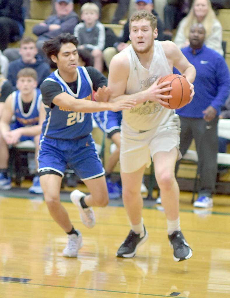 KEITH THORPE/PENINSULA DAILY NEWS Port Angeles Isaiah Shamp, right, heads for the lane as Bremertons Isaiah Cadengo closes in on Thursday night in Port Angeles.